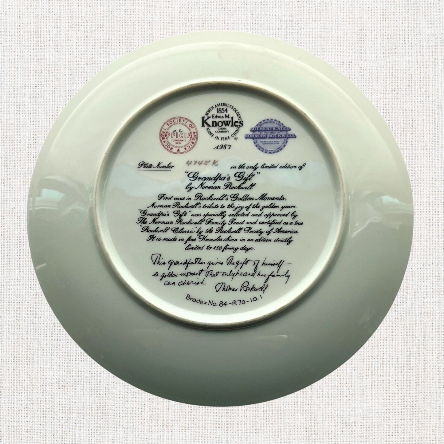 Norman rockwell grandpa's gift plate on neutral background, vintage home decor or collectible.