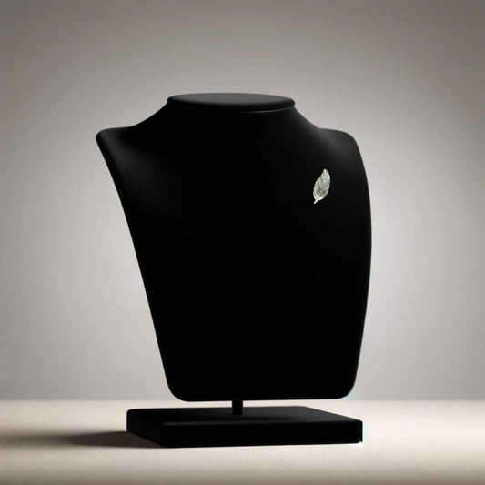 Mother of pearl miniature leaf brooch on neutral background, vintage home decor or collectible.