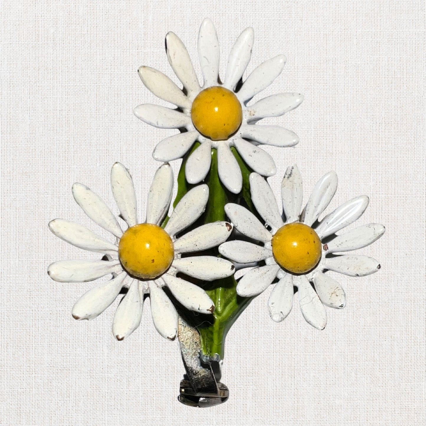 Cluster of white daisie's brooch on neutral background, vintage home decor or collectible.