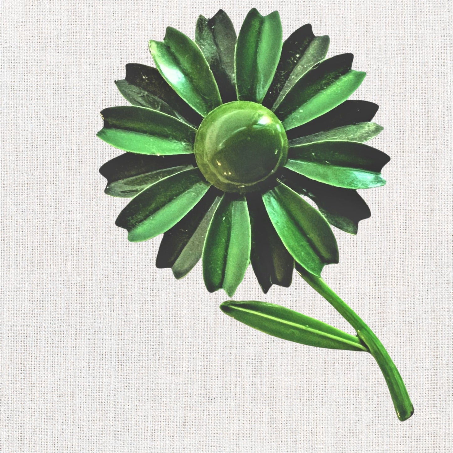 Green flower brooch with moveable stem on neutral background, vintage home decor or collectible.