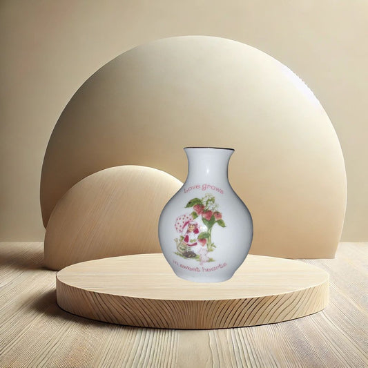 Strawberry Shortcake ceramic bud vase with vintage cartoon character , on neutral background, vintage home decor or collectible.