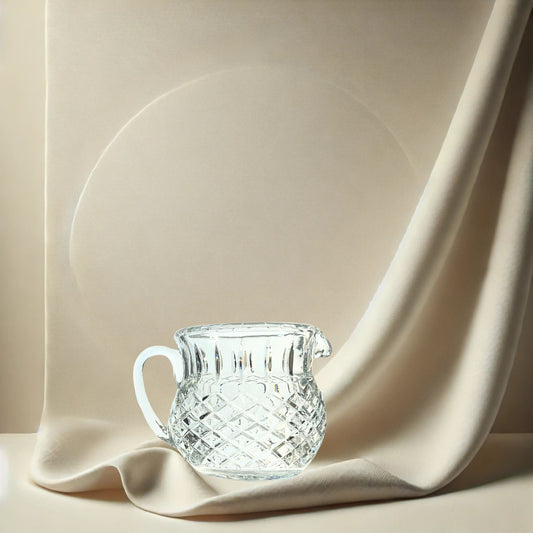 Diamond cut crystal stout pitcher on neutral background, vintage home decor or collectible.