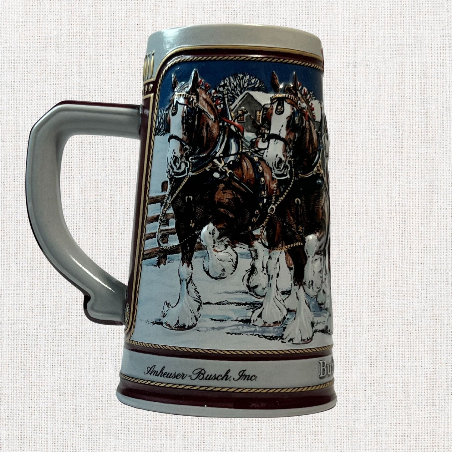 Budweiser 1989 ceramic beer stein with holiday Clydesdale scene, on neutral background, vintage home decor or collectible.