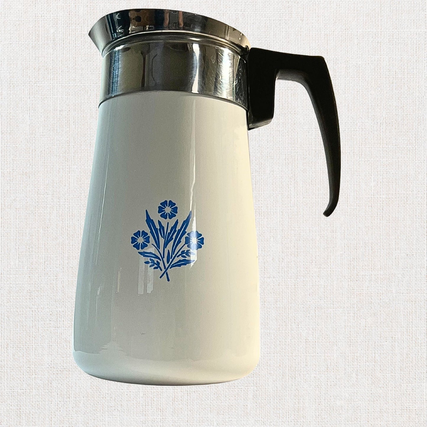 Corningware blue cornflower coffee pot on neutral background, vintage home decor or collectible.