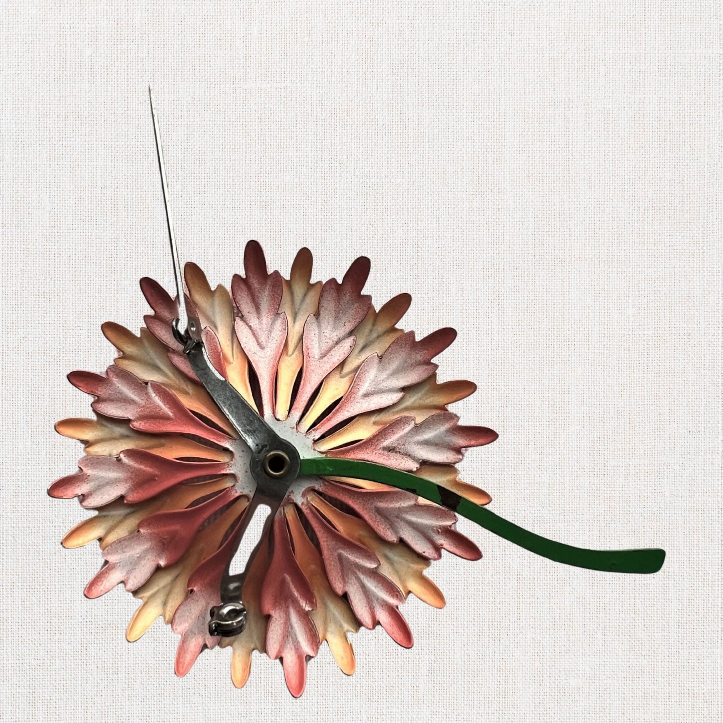 Pink flower brooch with moveable stem on neutral background, vintage home decor or collectible.