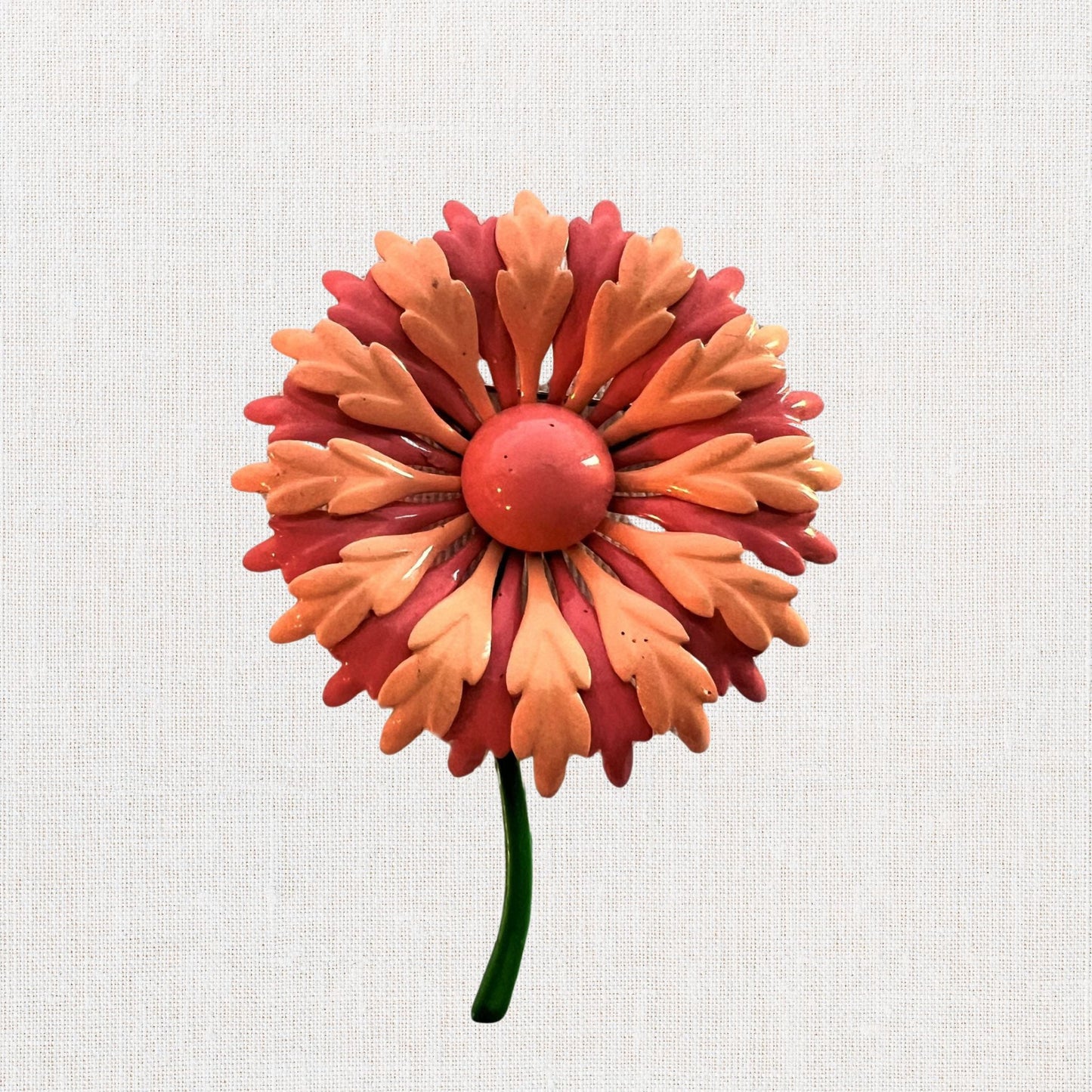 Pink flower brooch with moveable stem on neutral background, vintage home decor or collectible.