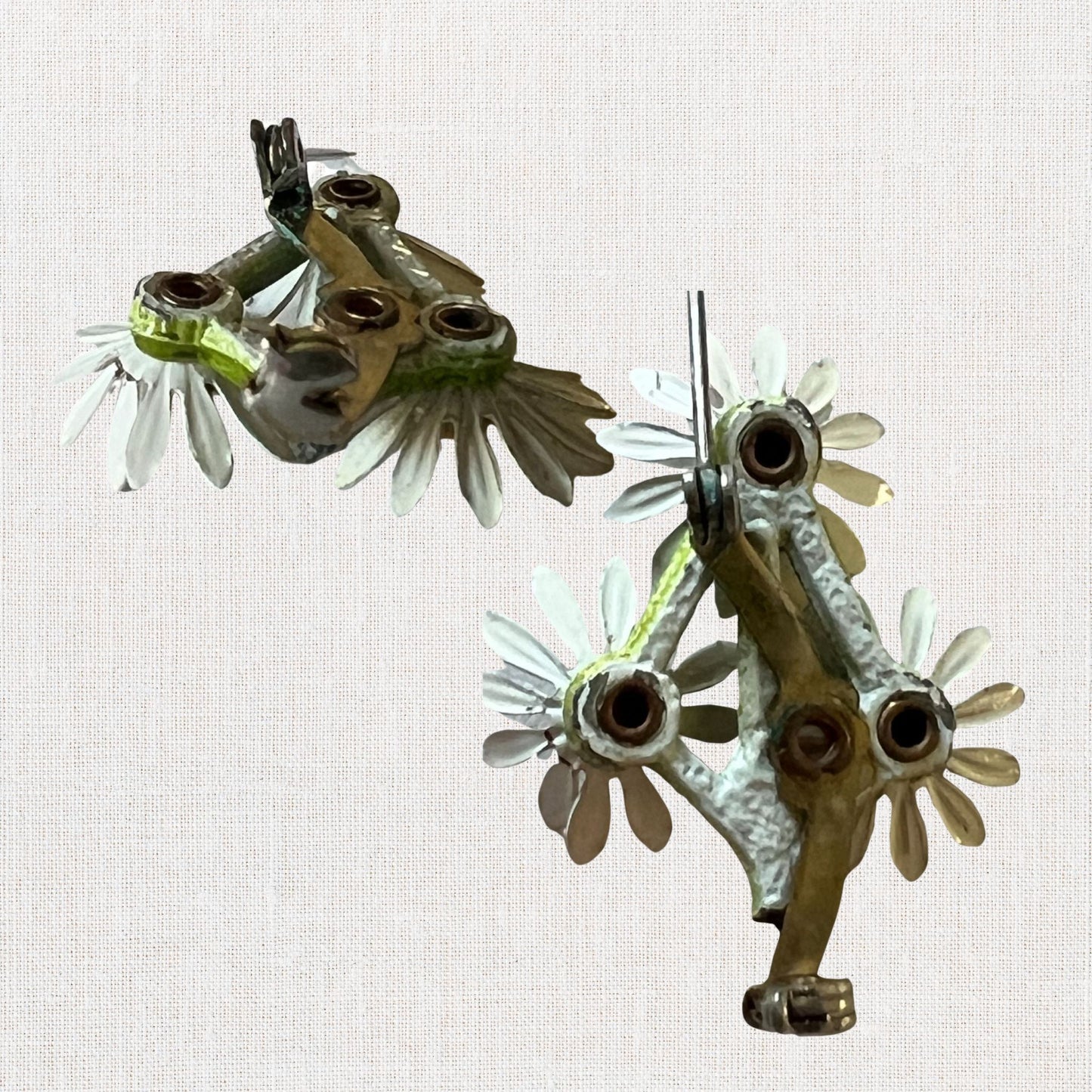 Cluster of white daisie's brooch on neutral background, vintage home decor or collectible.