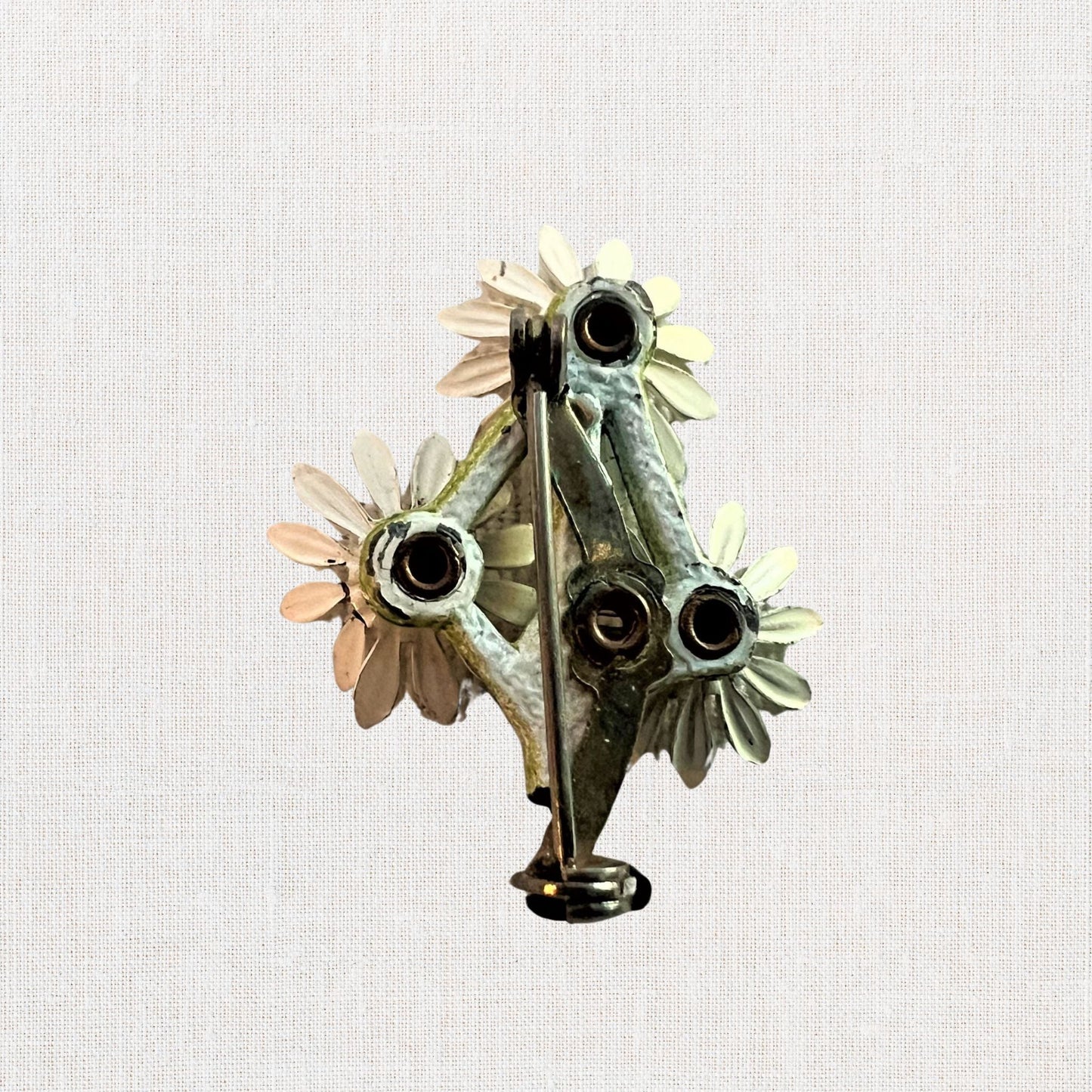 Cluster of white daisie's brooch on neutral background, vintage home decor or collectible.