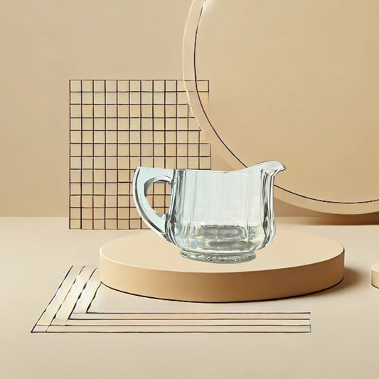 Clear glass ribbed creamer on neutral background, vintage home decor or collectible.