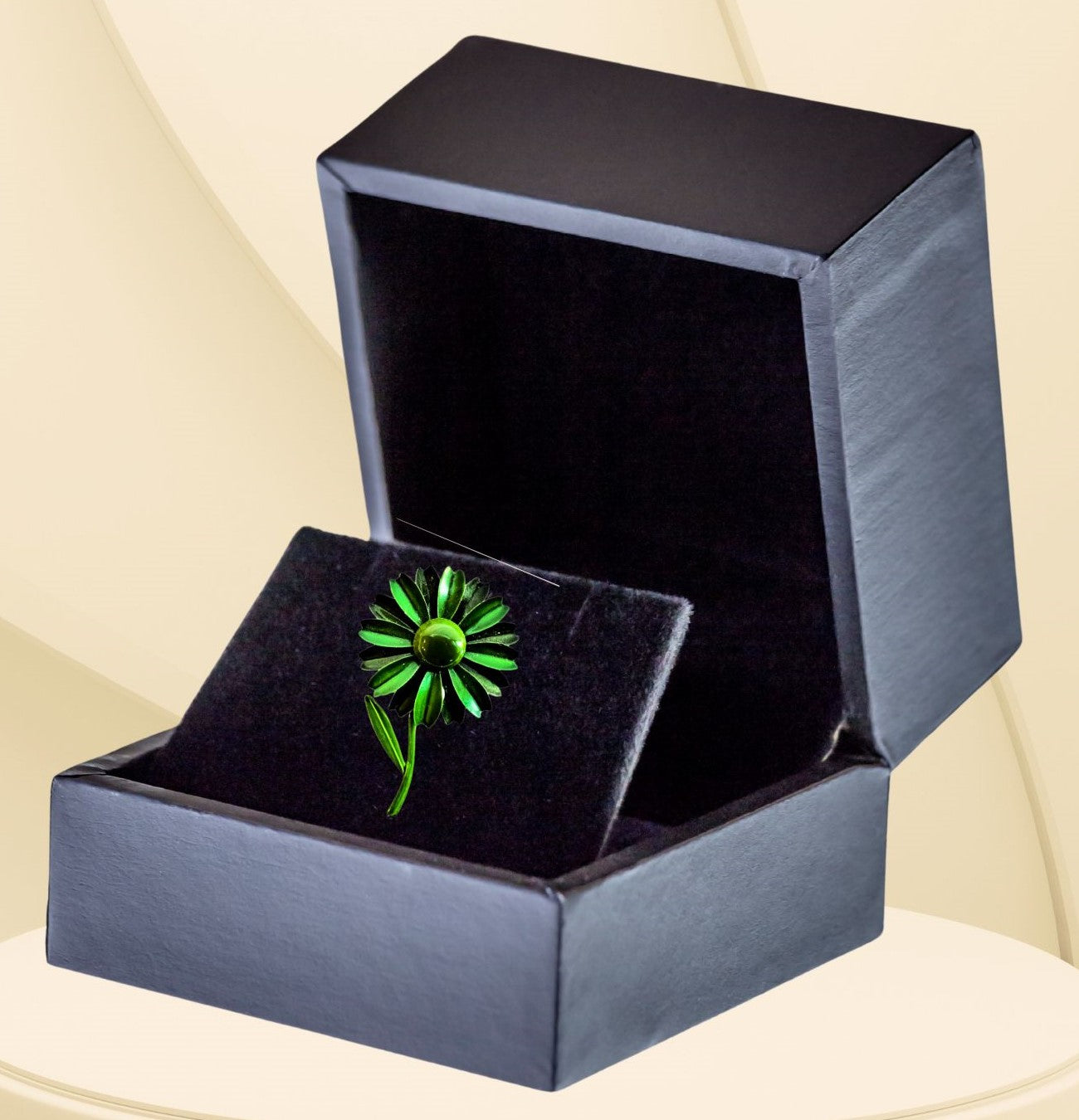 Green flower brooch with moveable stem on neutral background, vintage home decor or collectible.