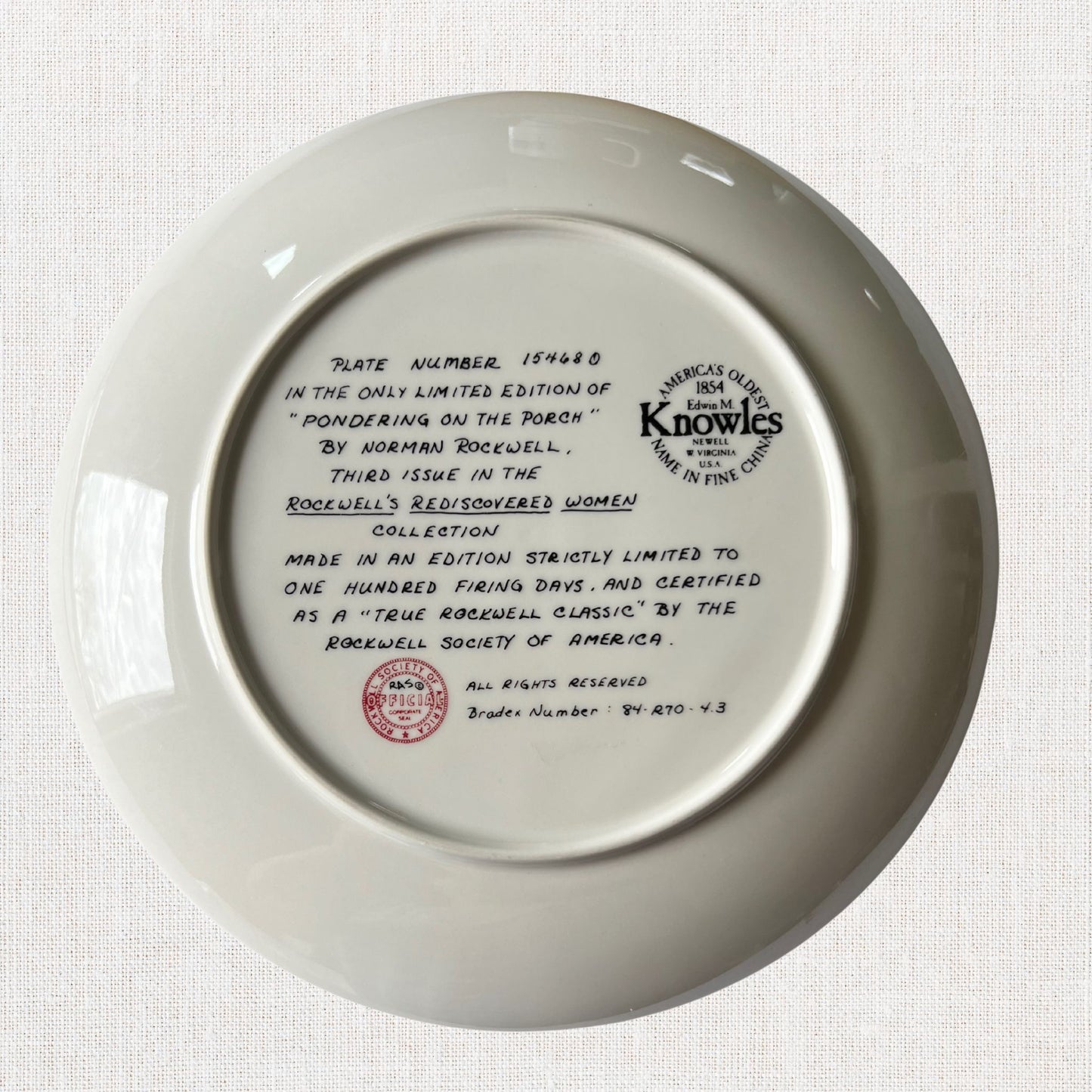 Norman rockwell pondering on the porch plate on neutral background, vintage home decor or collectible.