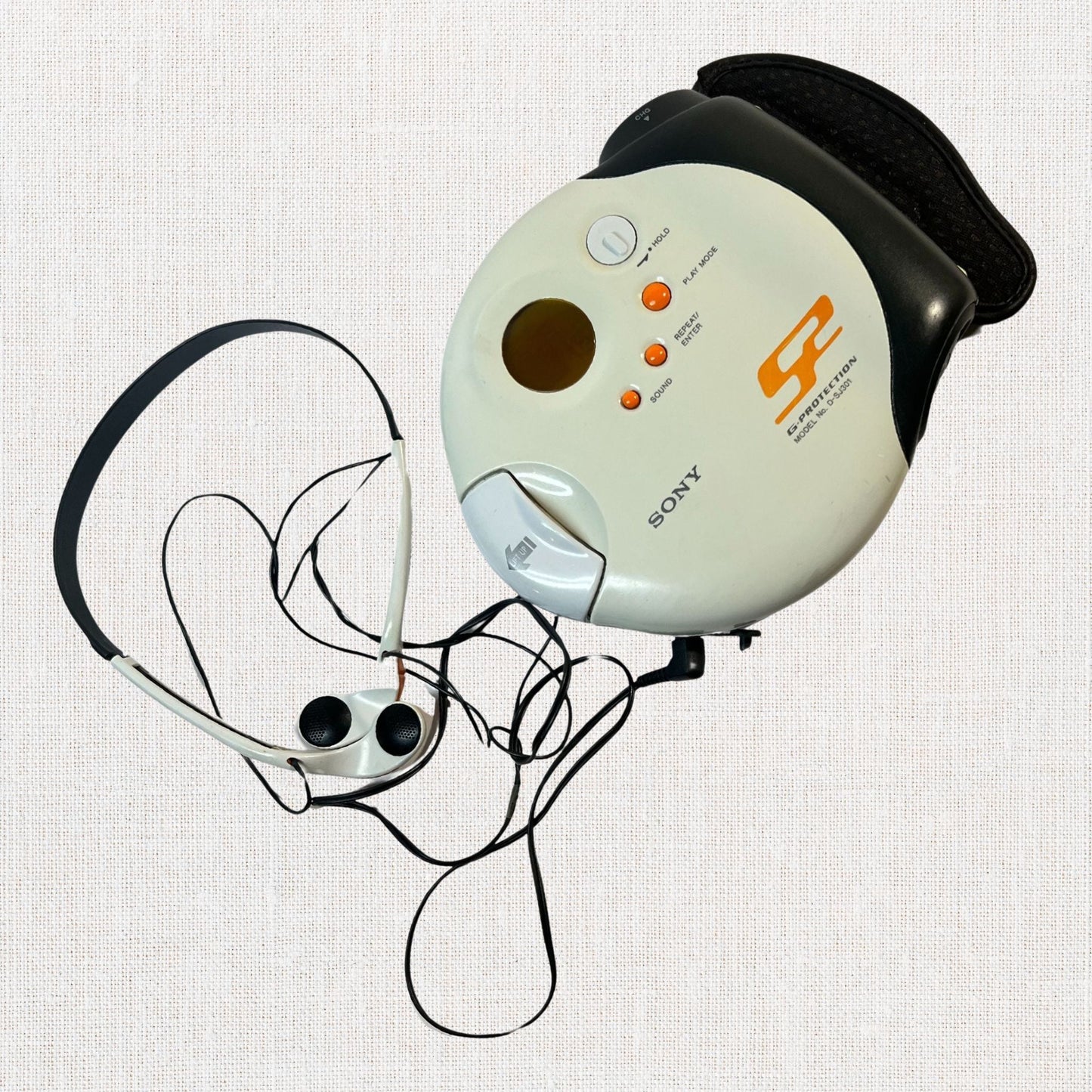 Sony discman model d-sj301 working on neutral background, vintage home decor or collectible.