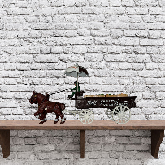 Cast iron horse drawn produce wagon on neutral background, vintage home decor or collectible.