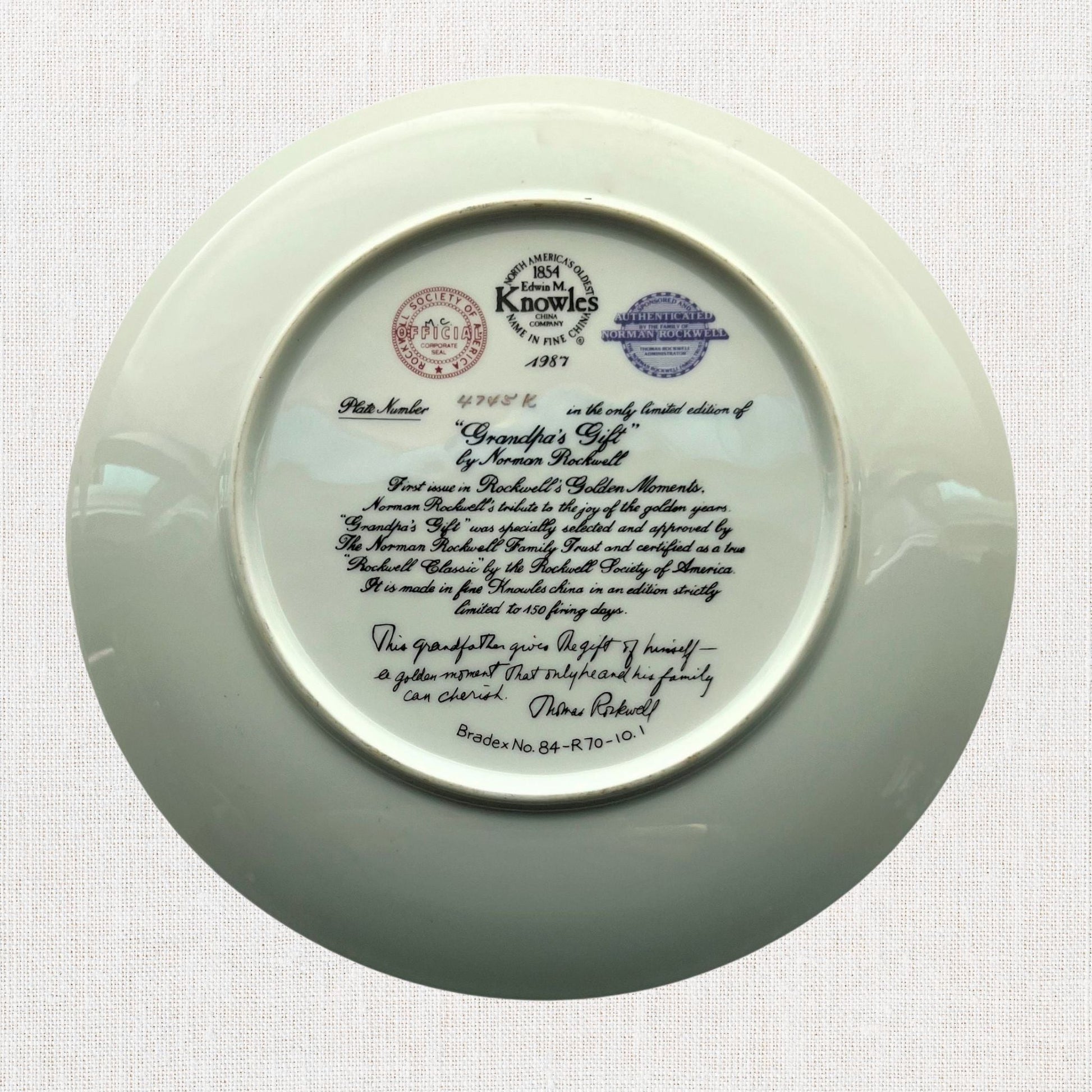 Norman rockwell grandpa's gift plate on neutral background, vintage home decor or collectible.