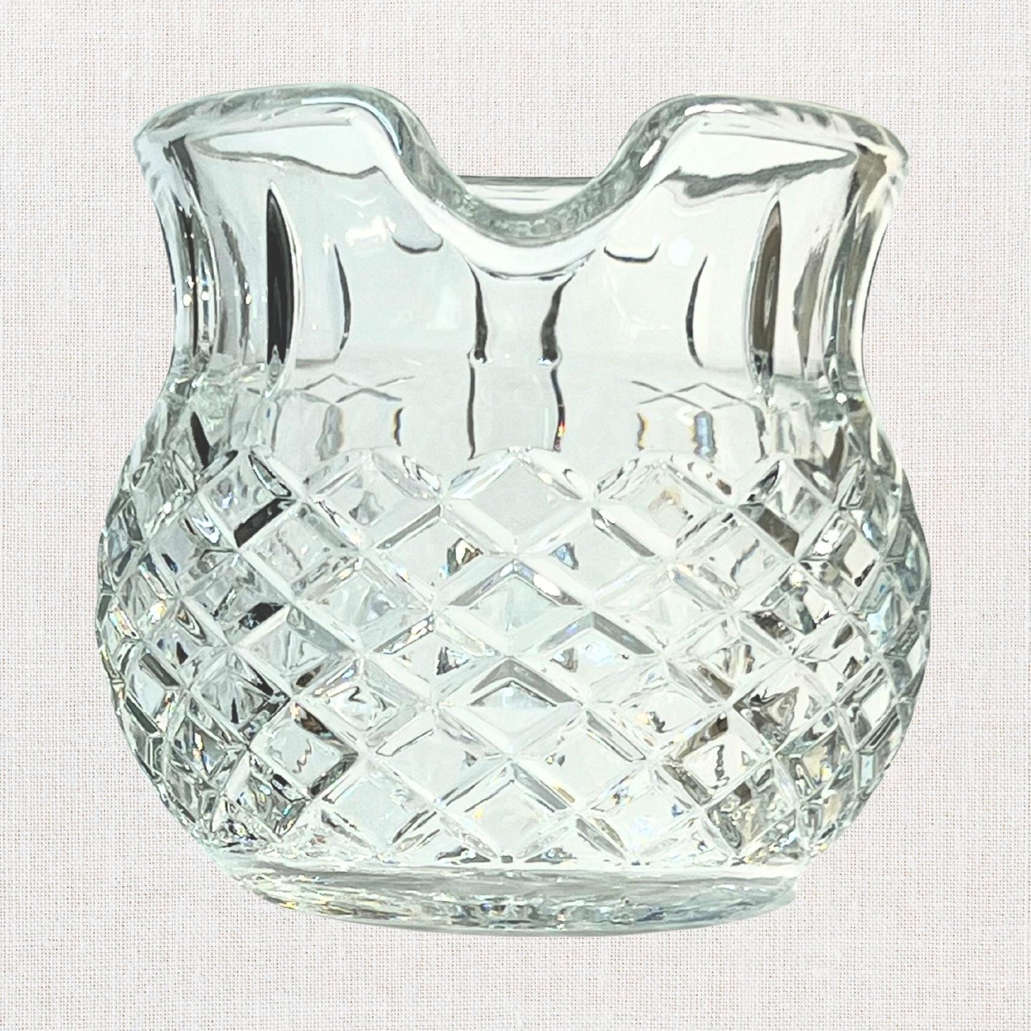 Diamond cut crystal stout pitcher on neutral background, vintage home decor or collectible.