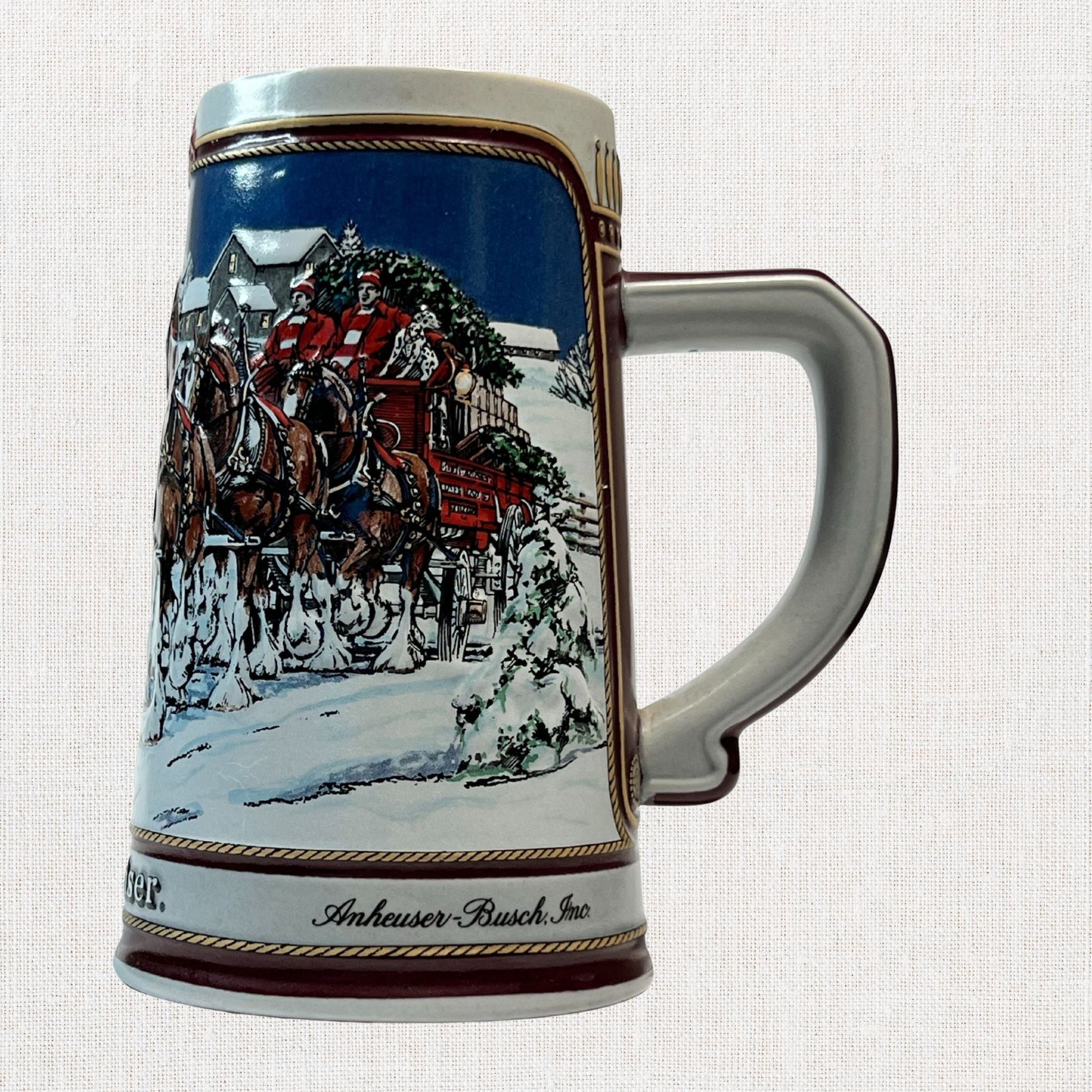 Budweiser 1989 ceramic beer stein with holiday Clydesdale scene, on neutral background, vintage home decor or collectible.