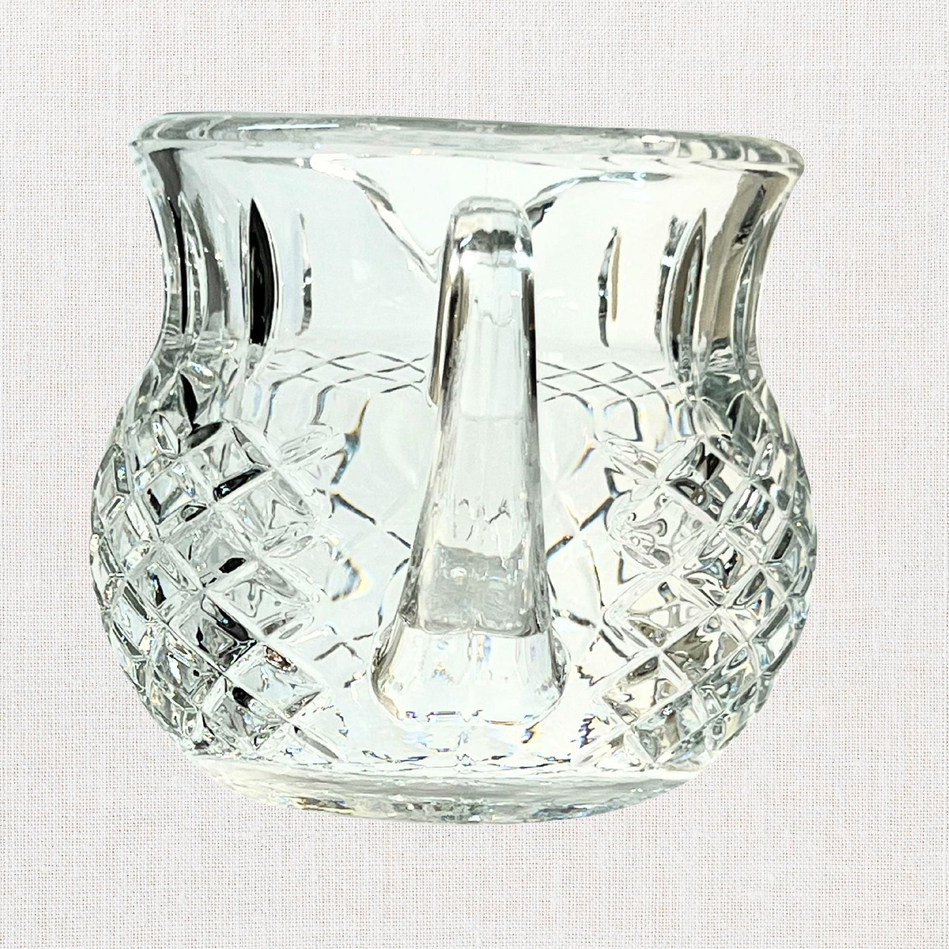 Diamond cut crystal stout pitcher on neutral background, vintage home decor or collectible.
