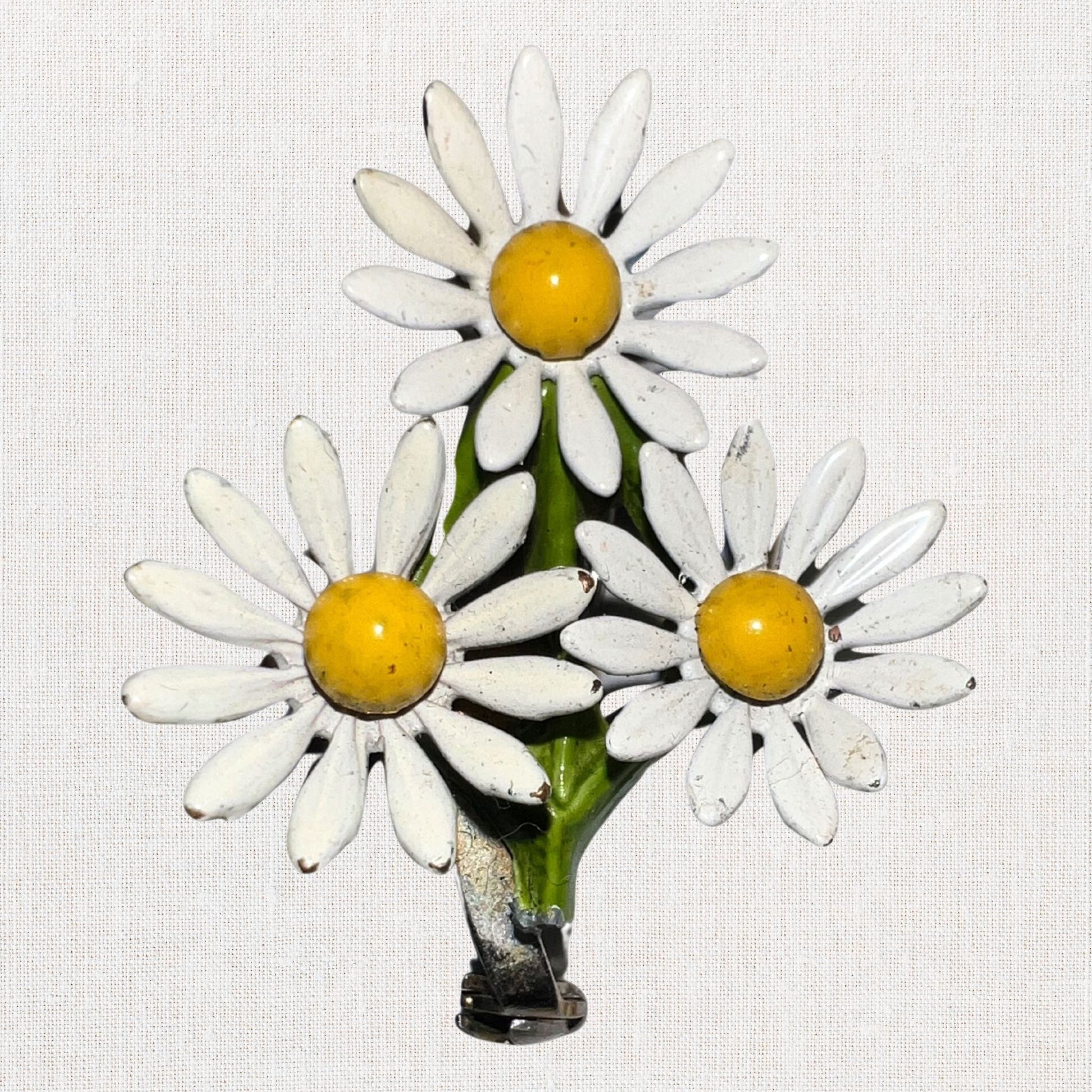 Cluster of white daisie's brooch on neutral background, vintage home decor or collectible.