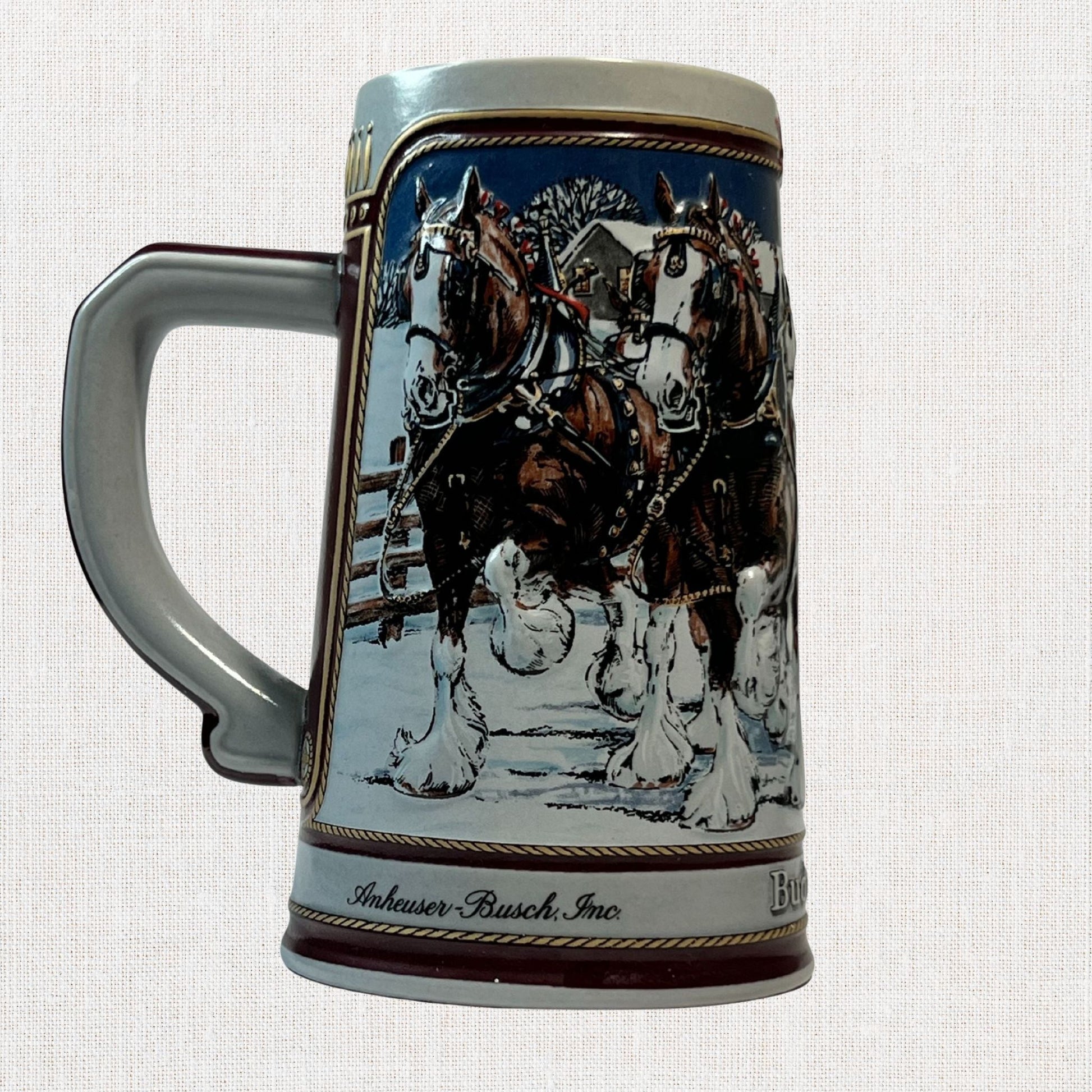 Budweiser 1989 ceramic beer stein with holiday Clydesdale scene, on neutral background, vintage home decor or collectible.