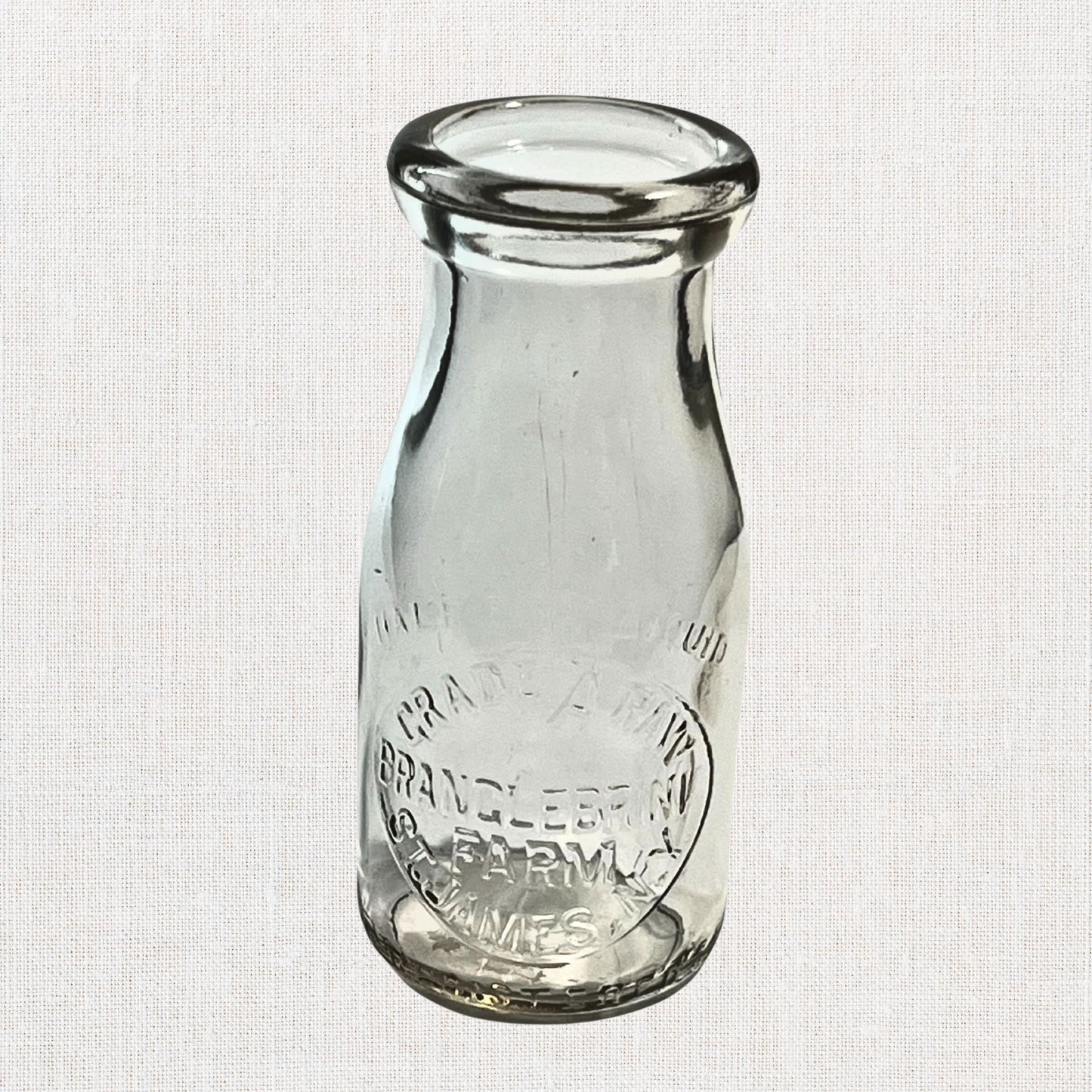 Branglebrink embossed cream bottles on neutral background, vintage home decor or collectible.