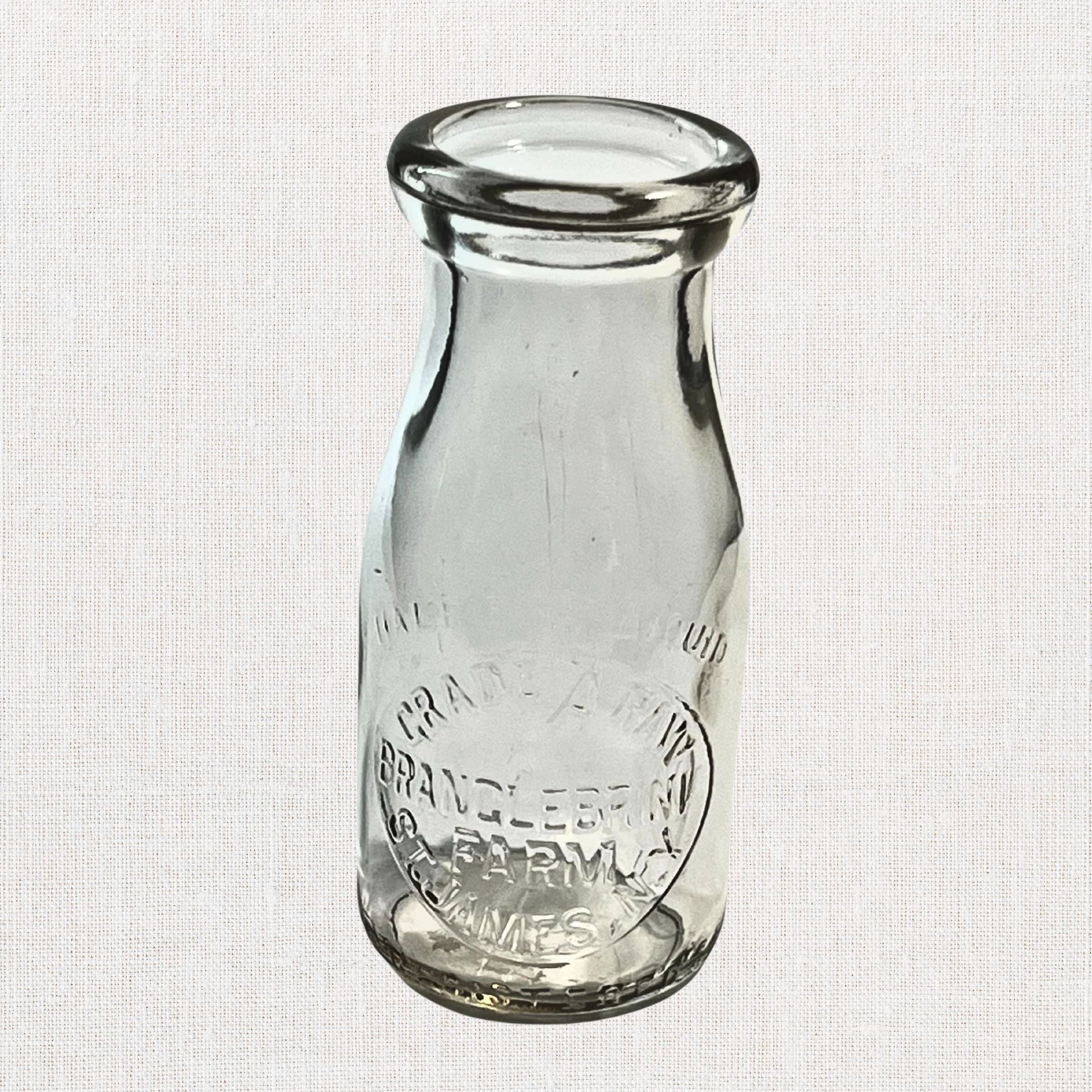 Branglebrink embossed cream bottles on neutral background, vintage home decor or collectible.