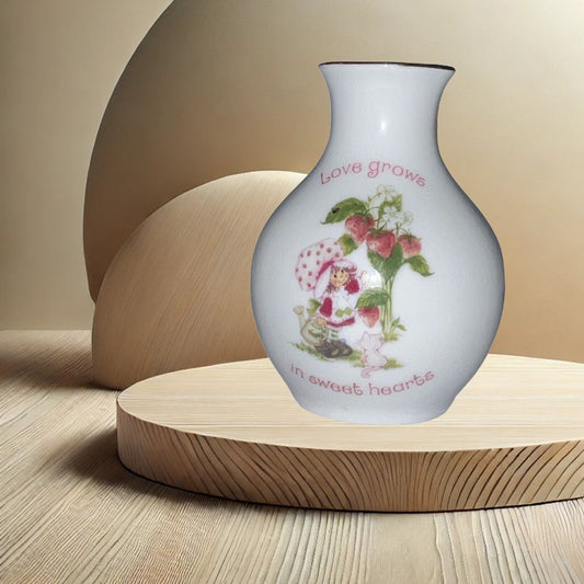 Strawberry Shortcake ceramic bud vase with vintage cartoon character , on neutral background, vintage home decor or collectible.