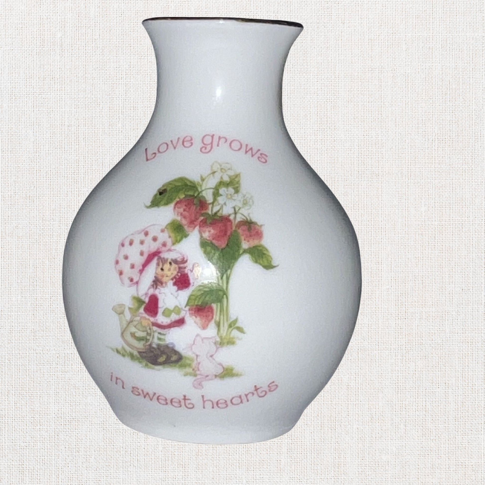 Strawberry Shortcake ceramic bud vase with vintage cartoon character , on neutral background, vintage home decor or collectible.