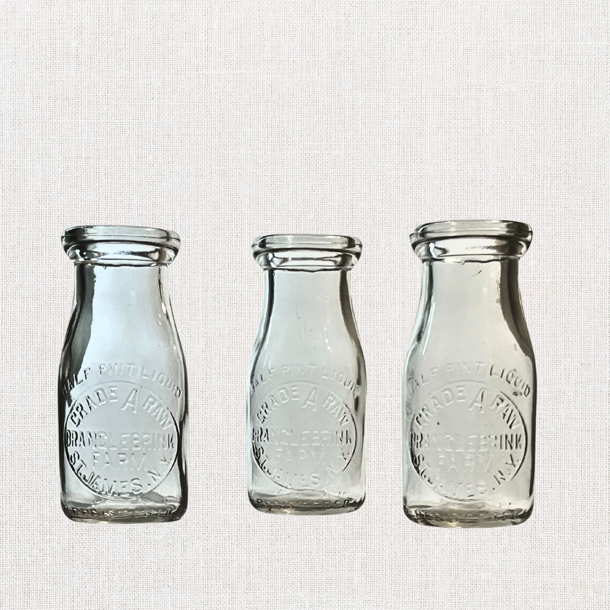 Branglebrink embossed cream bottles on neutral background, vintage home decor or collectible.