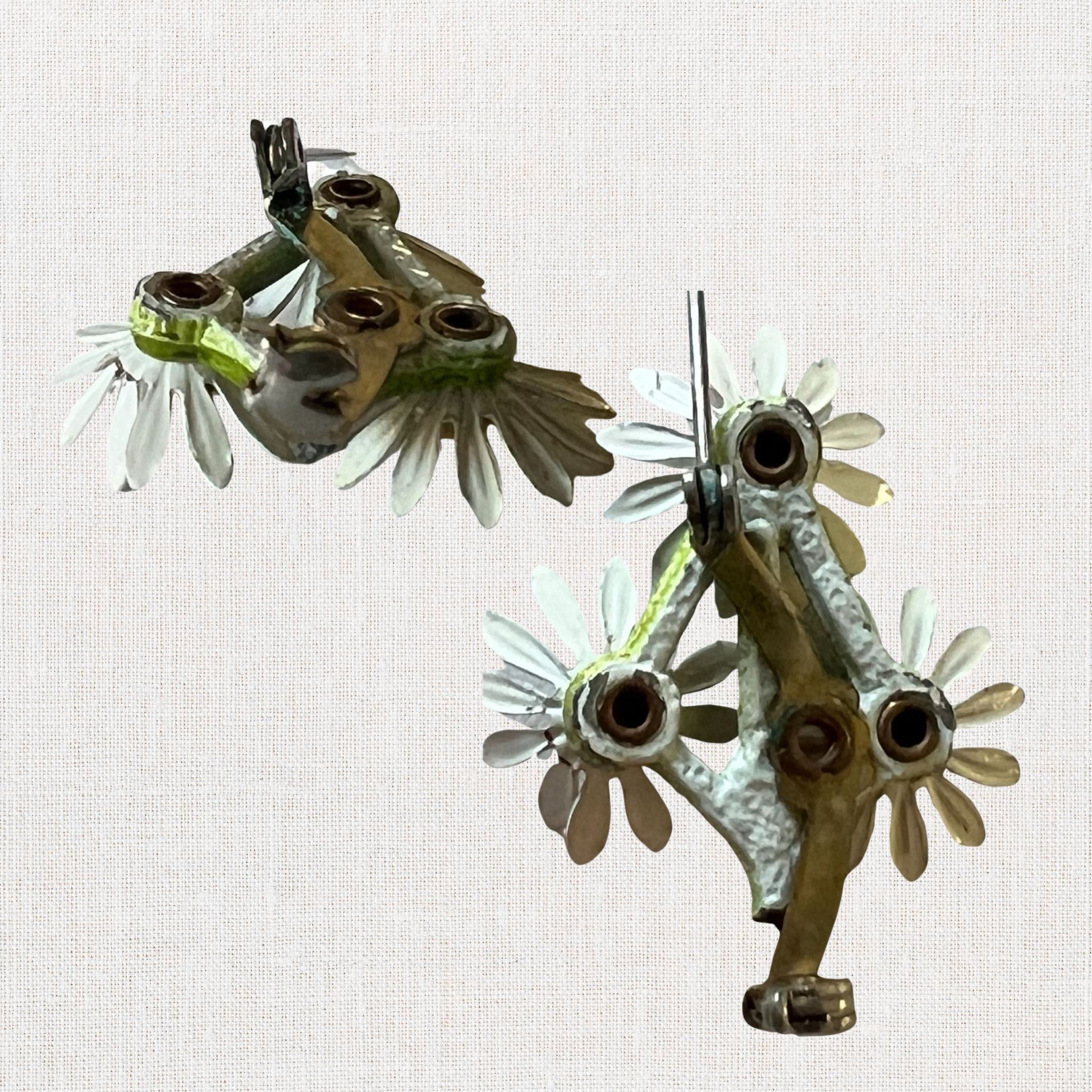 Cluster of white daisie's brooch on neutral background, vintage home decor or collectible.