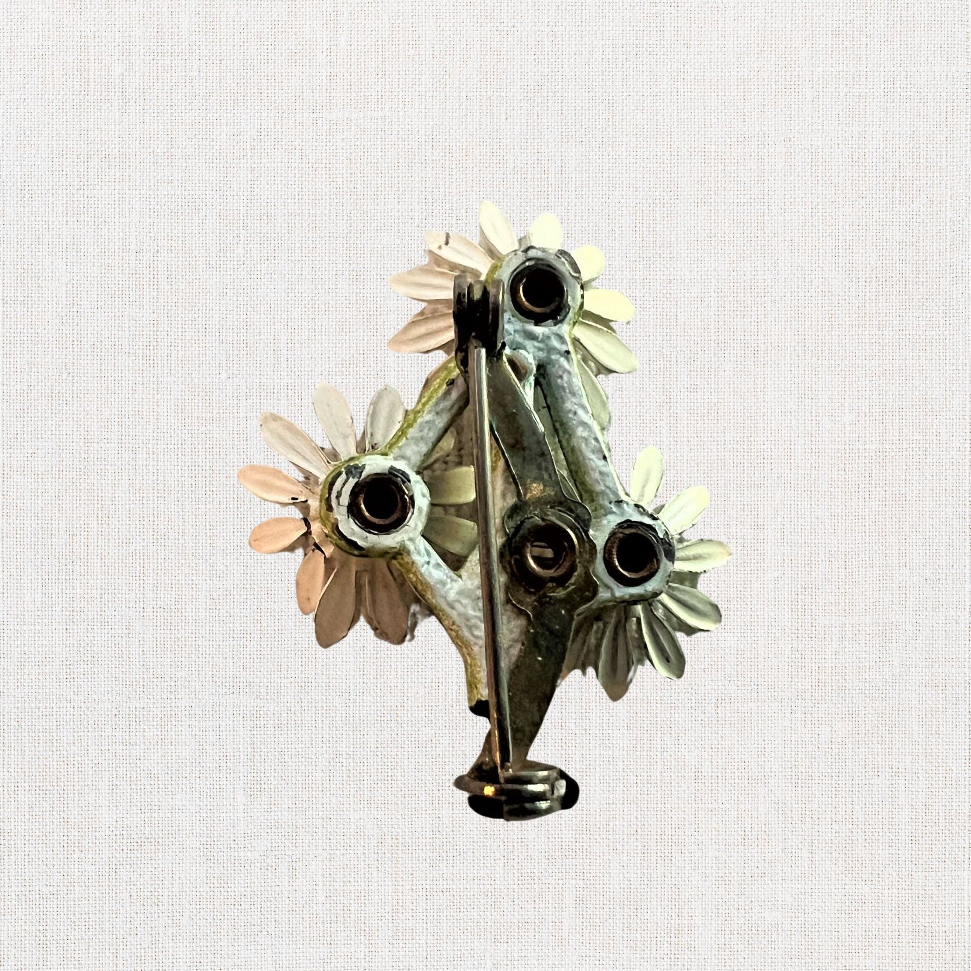 Cluster of white daisie's brooch on neutral background, vintage home decor or collectible.