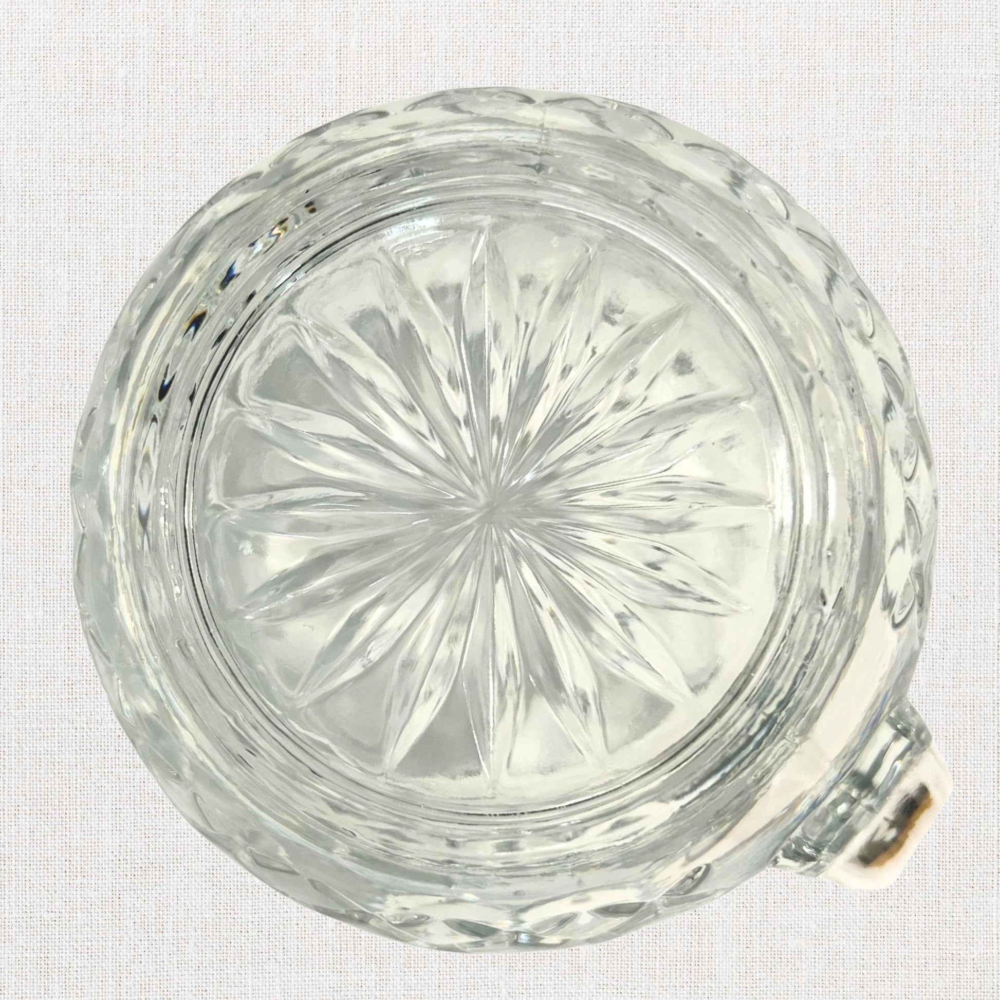 Diamond cut crystal stout pitcher on neutral background, vintage home decor or collectible.