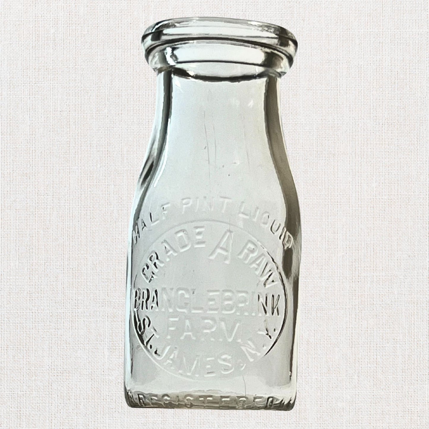 Branglebrink embossed cream bottles on neutral background, vintage home decor or collectible.