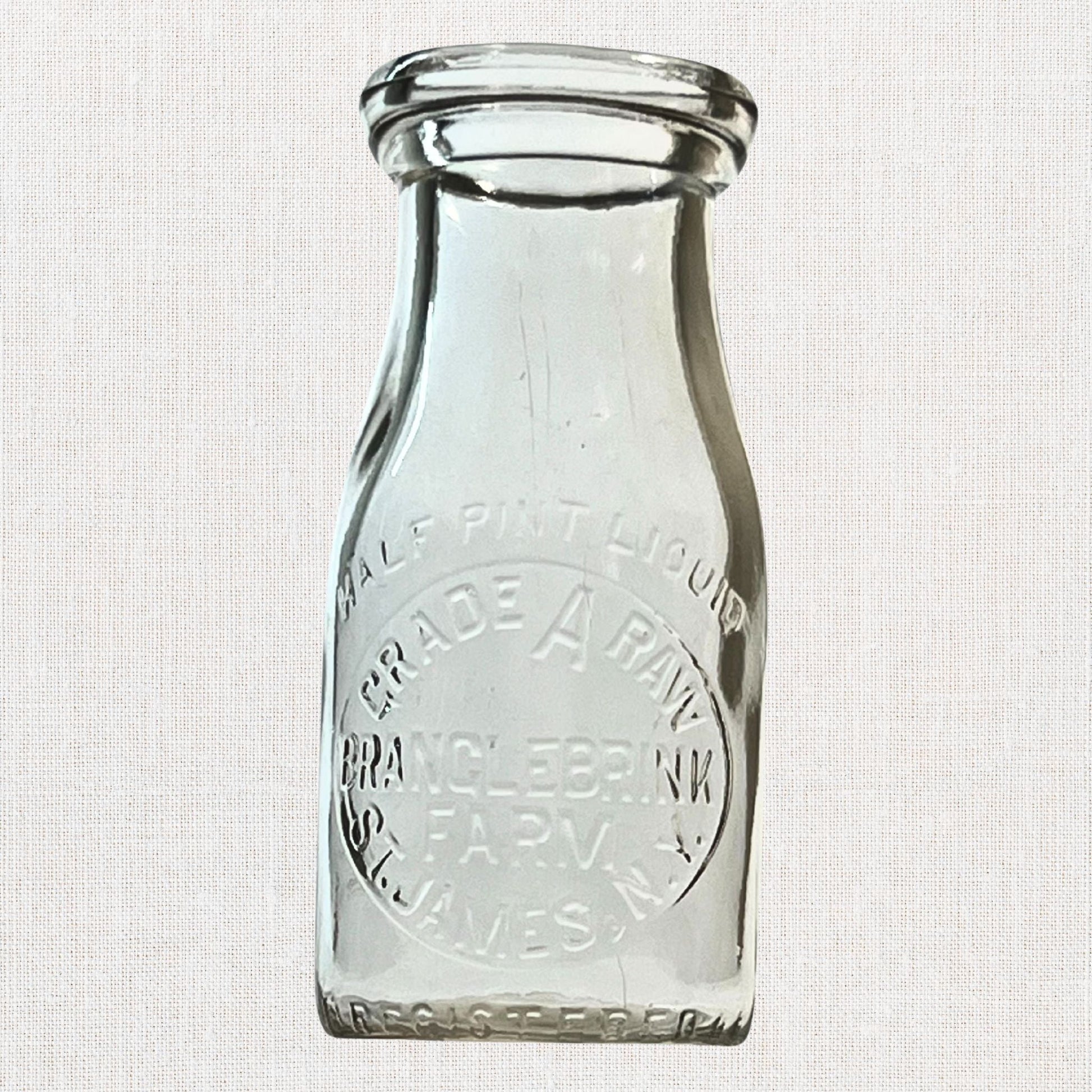 Branglebrink embossed cream bottles on neutral background, vintage home decor or collectible.