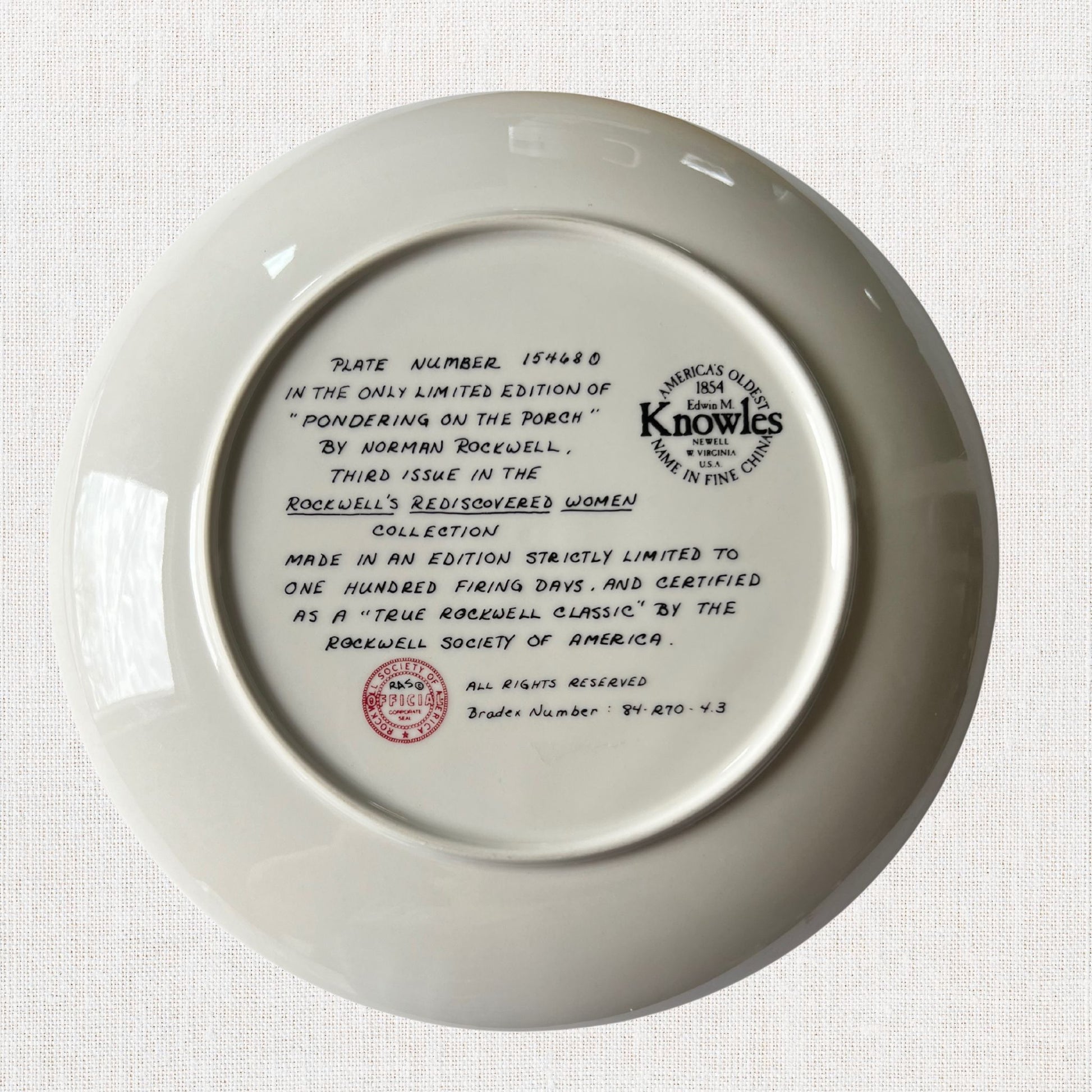 Norman rockwell pondering on the porch plate on neutral background, vintage home decor or collectible.