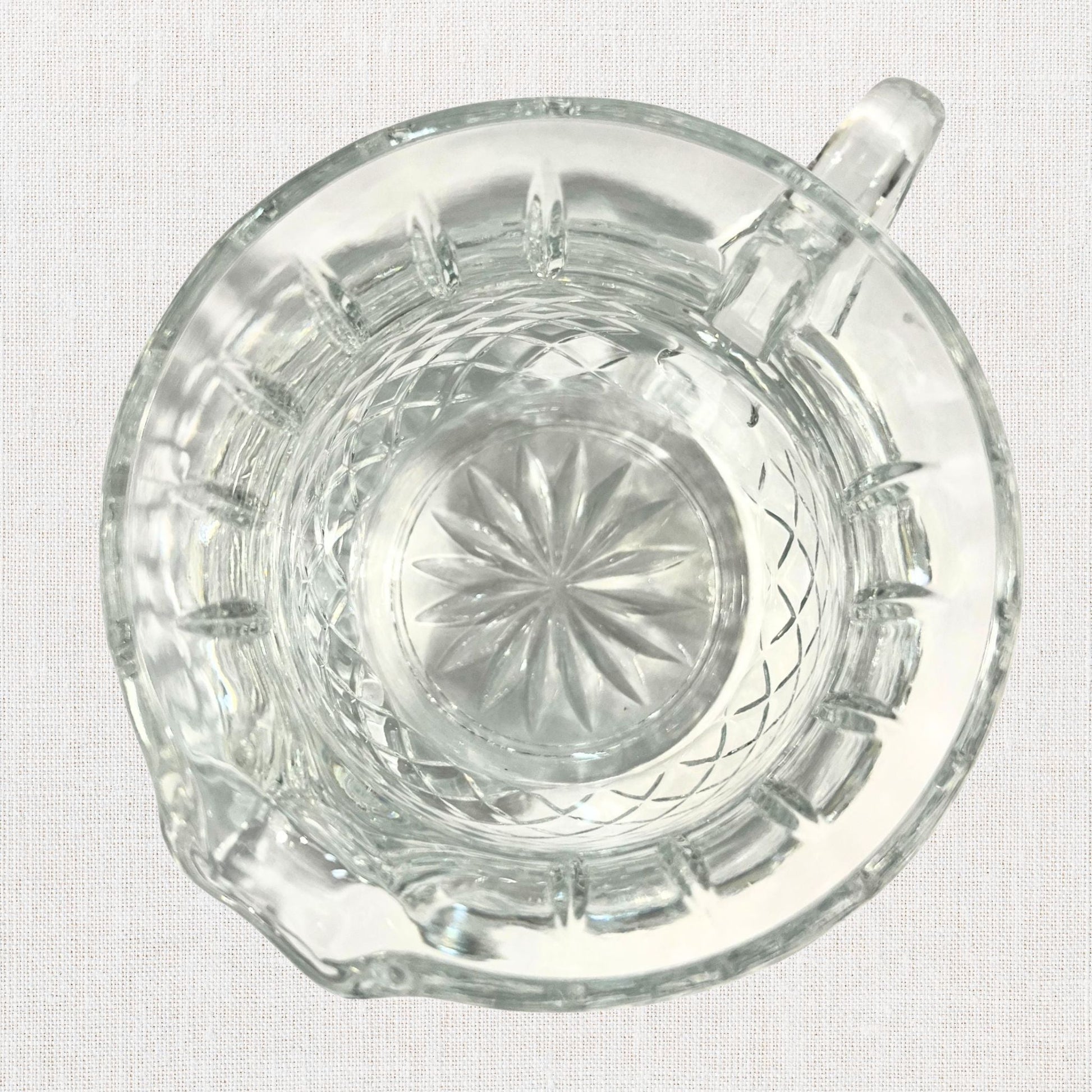 Diamond cut crystal stout pitcher on neutral background, vintage home decor or collectible.