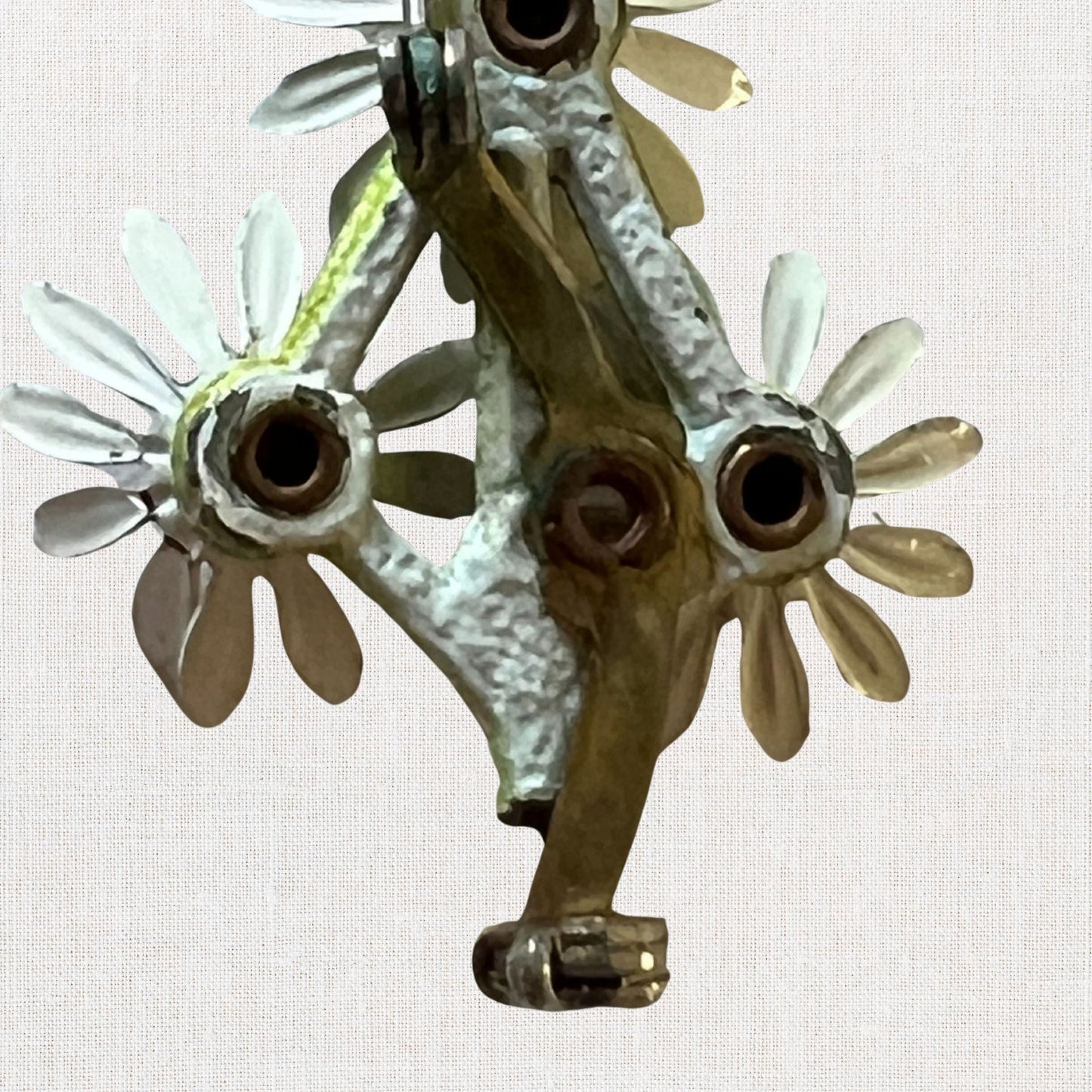 Cluster of white daisie's brooch on neutral background, vintage home decor or collectible.