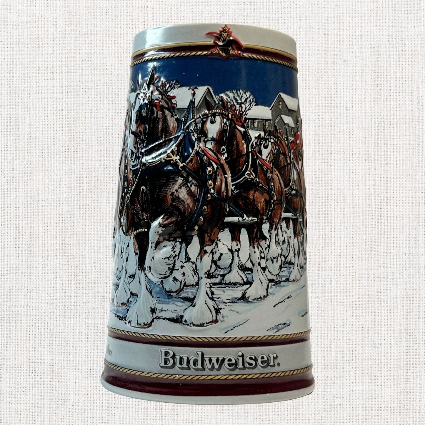 Budweiser 1989 ceramic beer stein with holiday Clydesdale scene, on neutral background, vintage home decor or collectible.