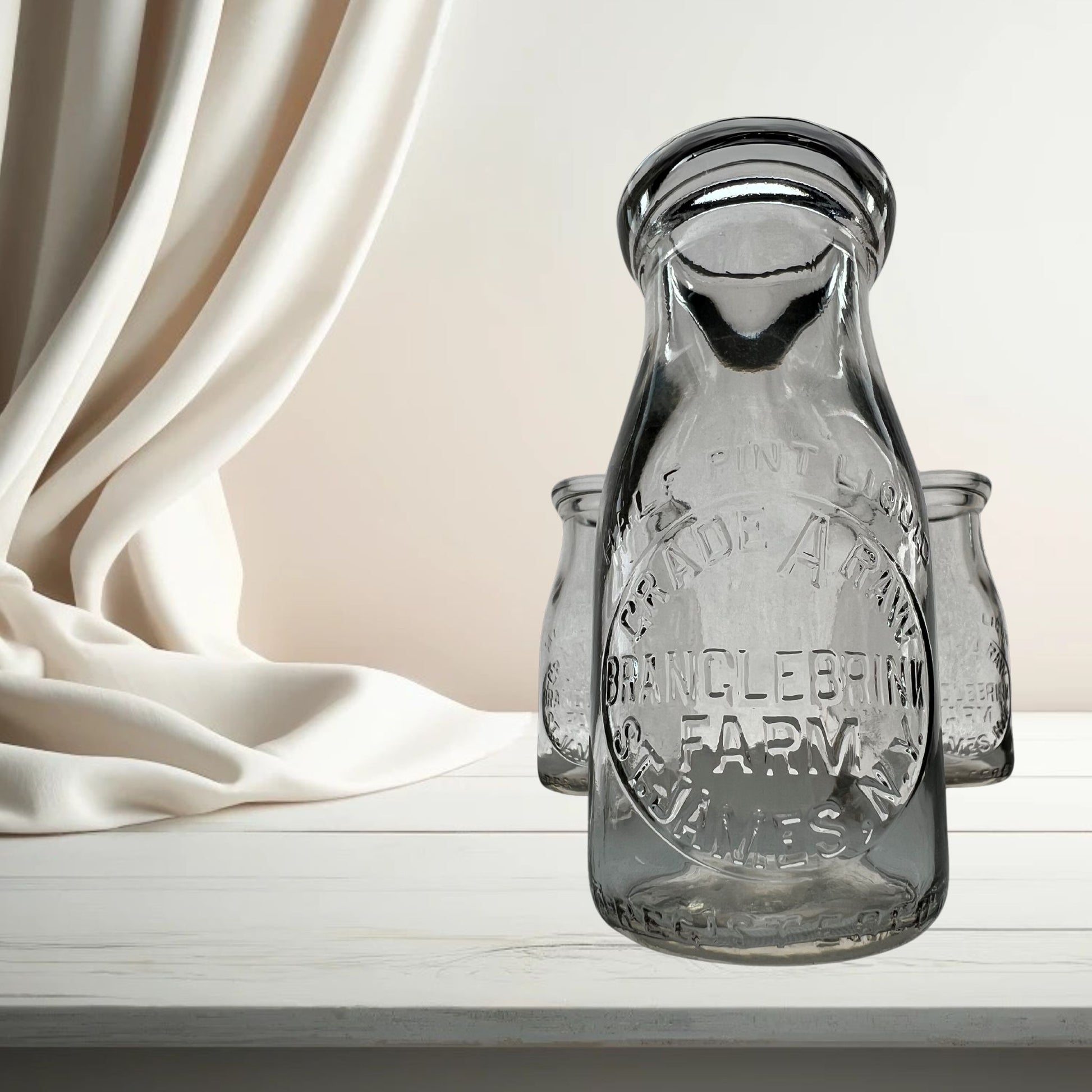 Branglebrink embossed cream bottles on neutral background, vintage home decor or collectible.