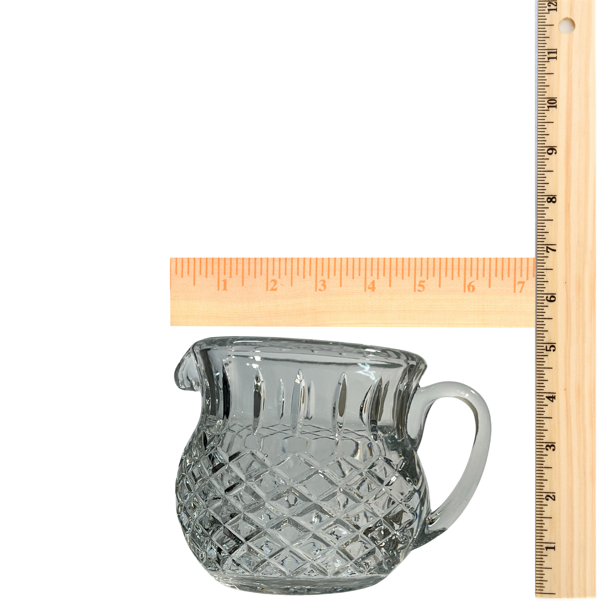 Diamond cut crystal stout pitcher on neutral background, vintage home decor or collectible.